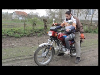 dad teaches daughter to ride a motorcycle